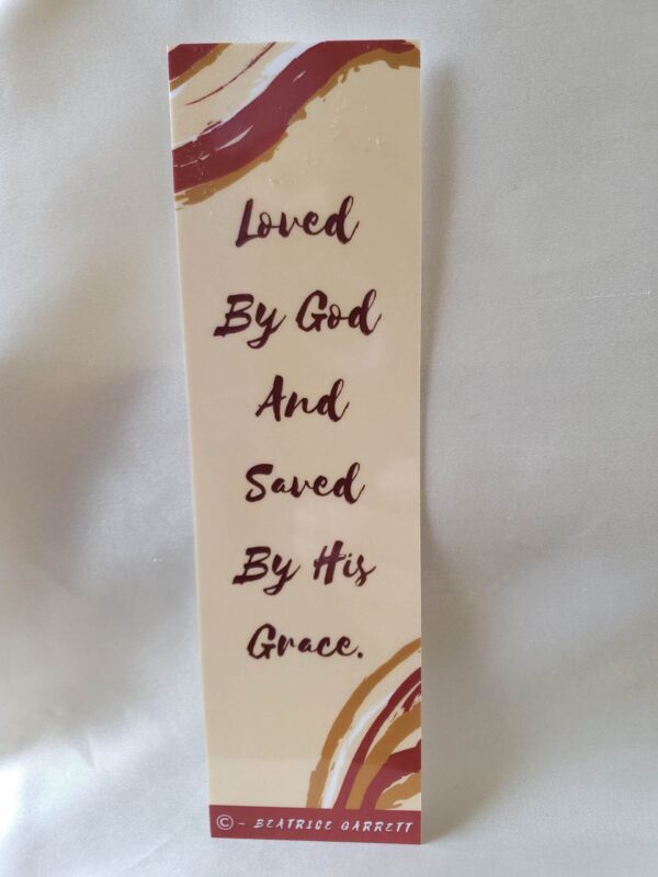 Love and Grace Laminated Bookmark classic tan background with red, tan, and white multicolored border frames the quote God’s love and grace in a classic red serif font by Beatrice Garrett.