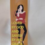 Love and Grace Laminated Bookmark mocha background with a faceless woman figure wearing black leggings and a red top and her elbow resting on her hand with two fingers gently placed on her face and a quote about love and grace by Beatrice Garrett