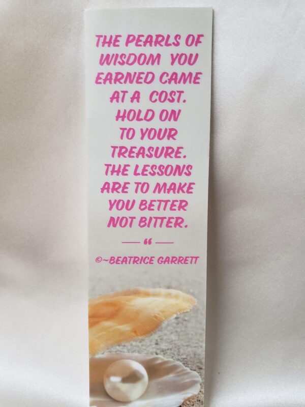 Wisdom Quote Laminated Bookmark tan design sandy background with a pearl in an open seashell and written an empowering quote about wisdom from Beatrice Garrett in pink.